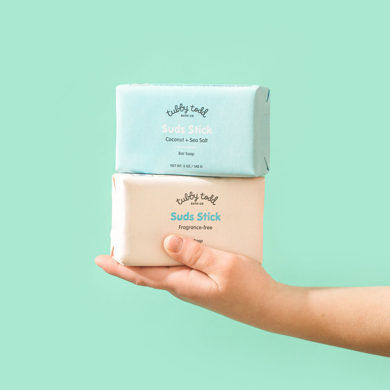 Hand holding Suds Stick bar soap